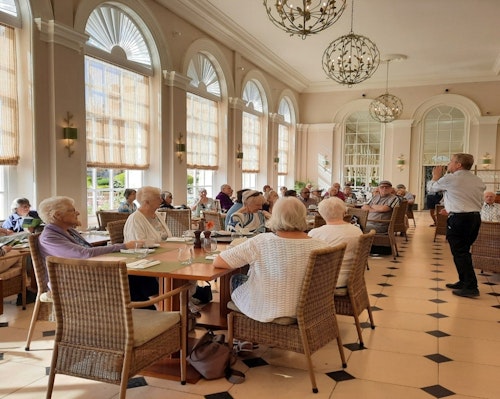 Guests listening to a talk in the Orangery